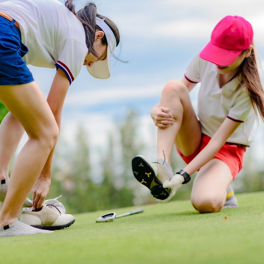 Women playing golf with lightweight cushioning and waterproof leather shoes