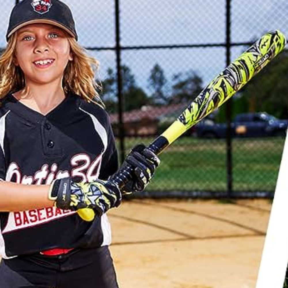 A picture of a young athlete measuring the length of a tee ball bat