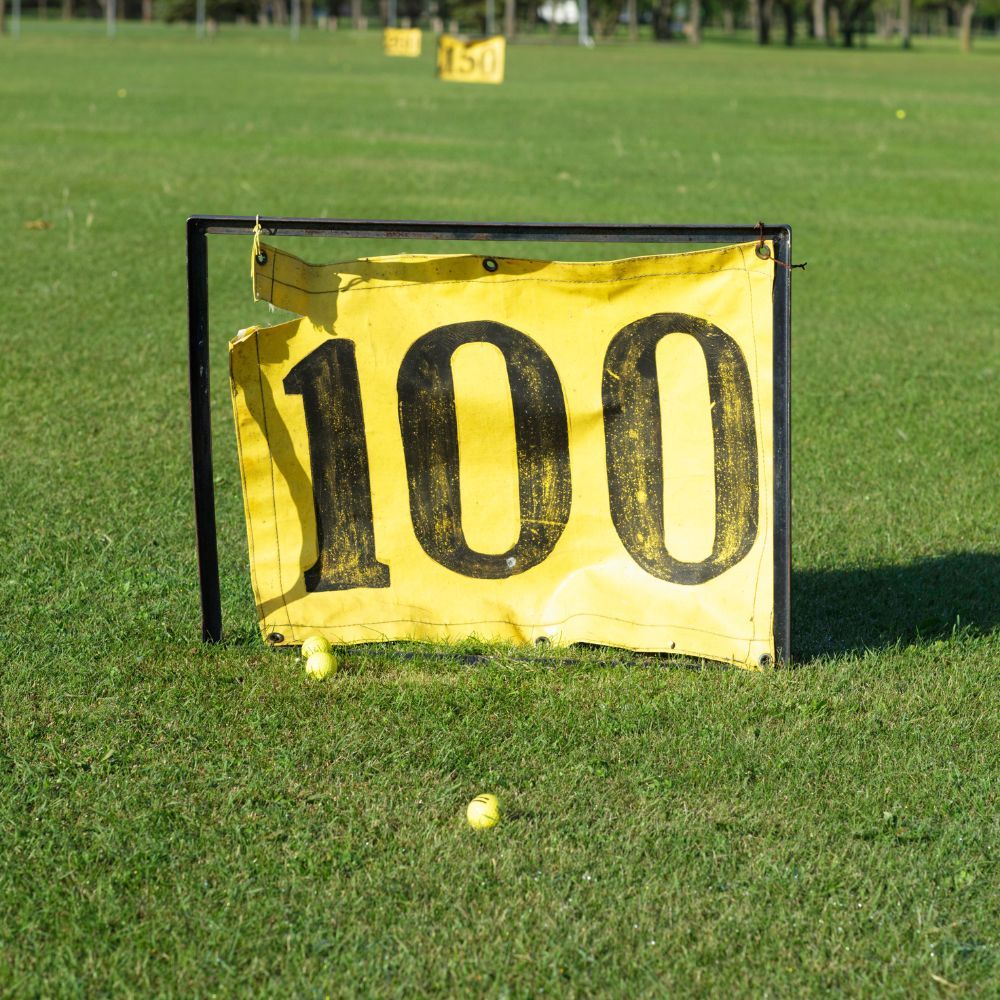 A golf ball on a tee, ready to be hit