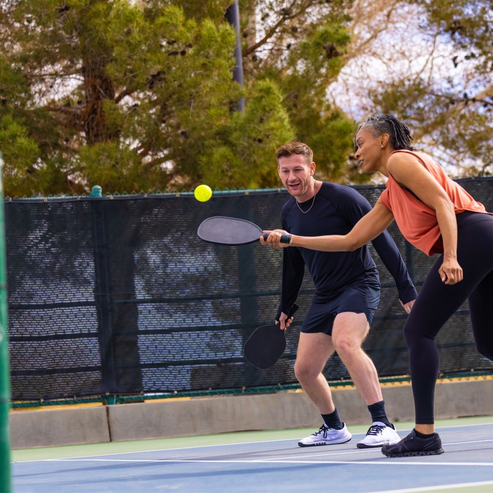 An image showing a player hitting a pickleball with proper form, demonstrating pickleball tips for dinks and drops.