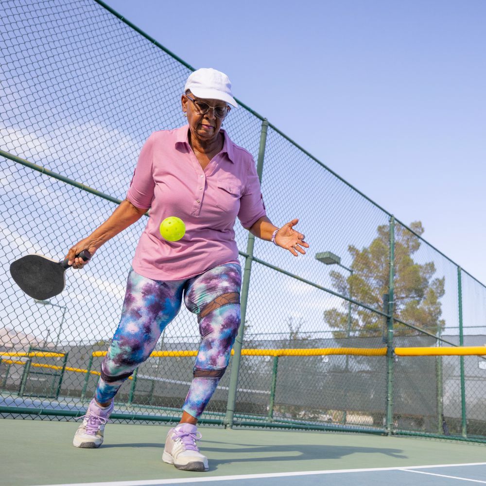 A pickleball player hitting a groundstroke