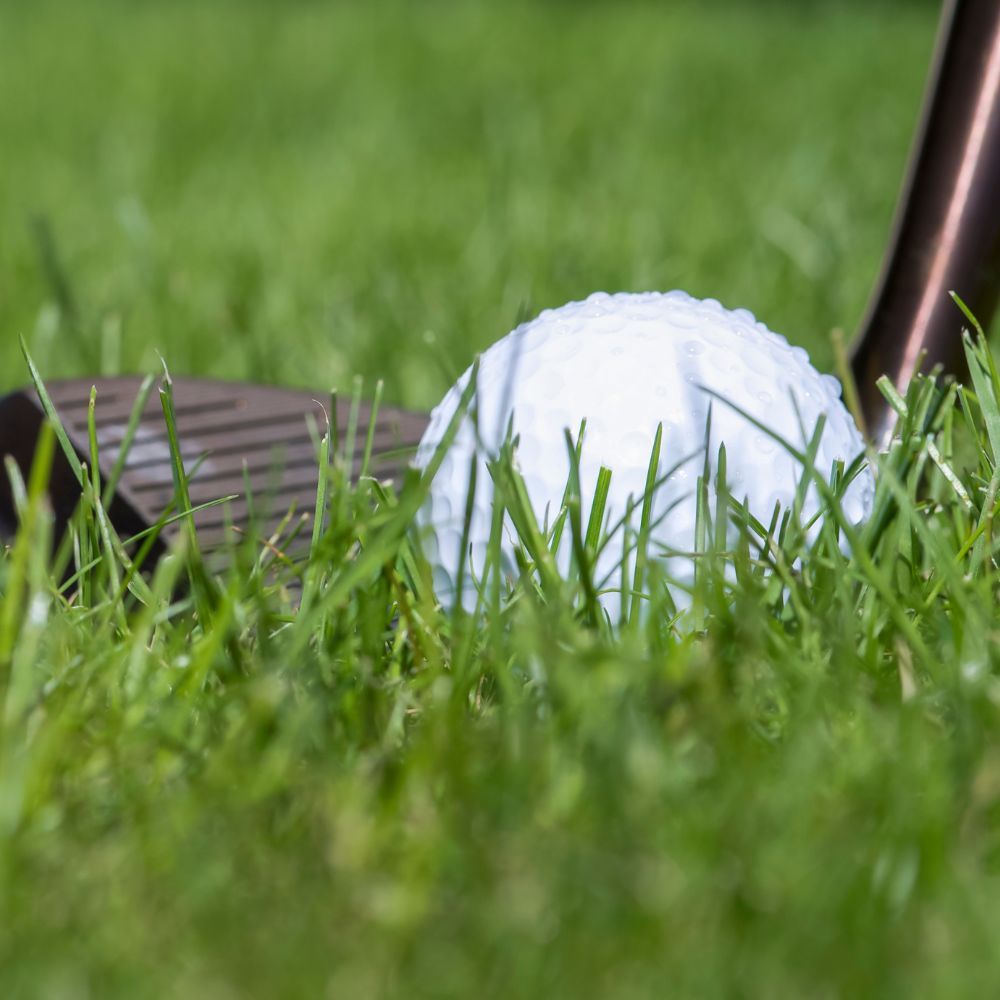 A golfer holding a cavity back wedge