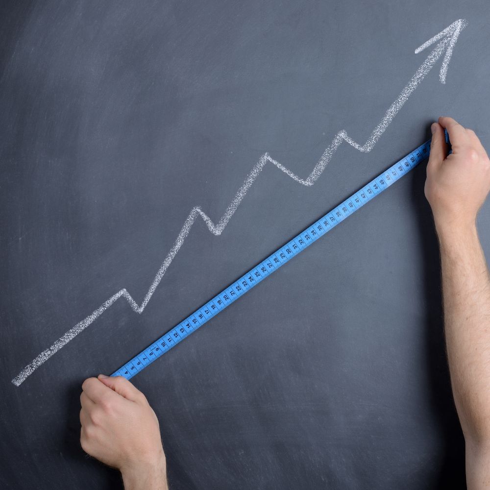 A person holding a clipboard with a brand logo and a graph on it.