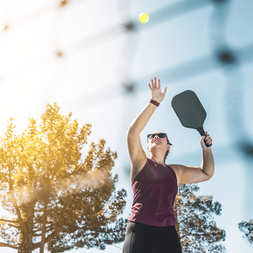 woman serving pickleball